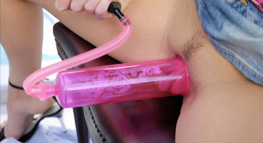 Woman using a penis pump to suction her vagina.